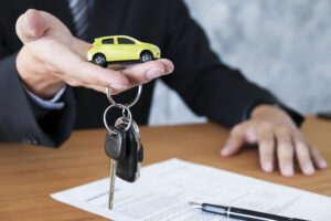 Los ANgeles buy here pay here - Business concept car insurance sell and buy car car financing car key for Vehicle Sales Agreement.